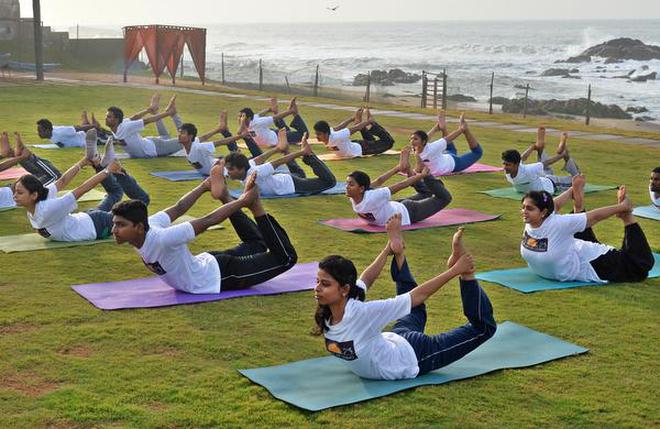 yoga asanas conducted by Art of Living as a precursor to the International Yoga Day in Visakhapatnam on June 15, 2016. International Yoga Day is celebrated on June 21.