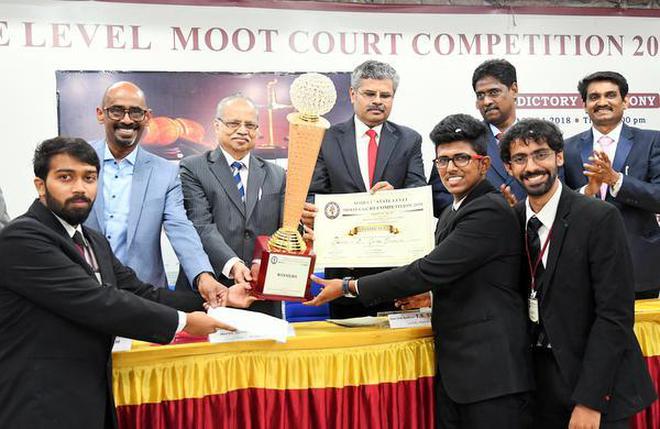 Winners receive their prize from Judge T.S. Sivagnanam and former Judge K. N. Basha in Madurai on Saturday.