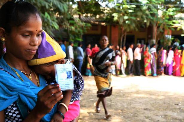 Mumbai: May 28, 2018. Nirmal Bharat Waghlode of Amangaon flashes her voter ID card after casting vote at Aamgaon in Palghar district on Monday. Aamgaon people are irritated with the proposed bullet train project, which would take away their land. The by-election for Lok Sabha seat in Palghar of Maharashtra being conducted today. Photo: Arunangsu Roy Chowdhury.