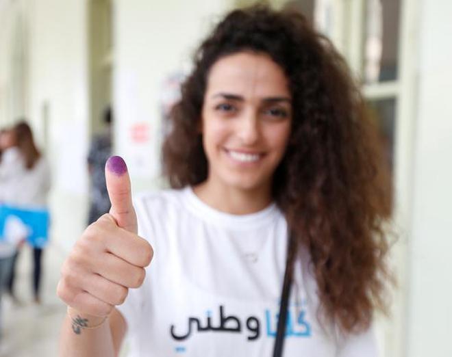 A woman shows her ink-stained finger after casting her vote during the parliamentary election in Lebanonâs capital Beirut on May 6, 2018.