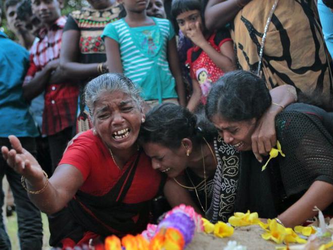 Sri Lankan Tamils in Mullivaikkal cry at the graves of their relatives who died in Eelam War IV. File
