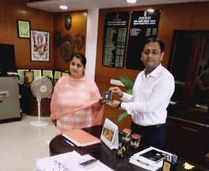 Lucknow regional passport officer Peeyush Verma gives Tanvi Seth her passport.