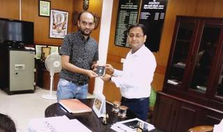 Lucknow regional passport officer Peeyush Verma gives Anas Siddiqui his passport.