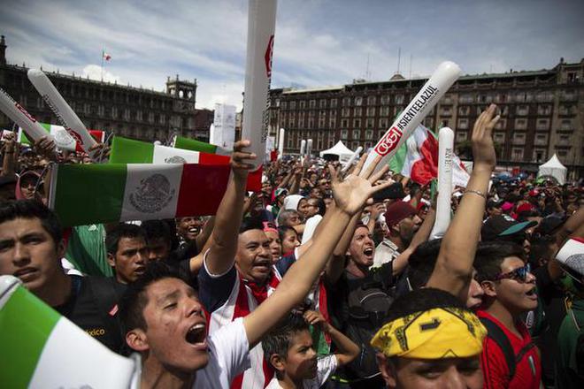 Fan's celebrate Mexico's win as they watched it on an outdoor screen in Mexico City's Zocalo,