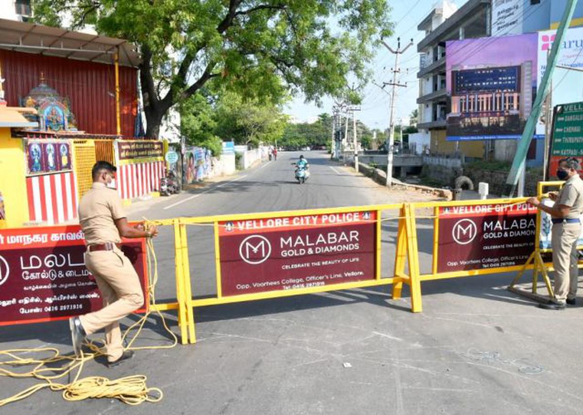Policemen erect barrigades to enforce the complete lockdown in Vellore on Monday, May 10, 2021.
