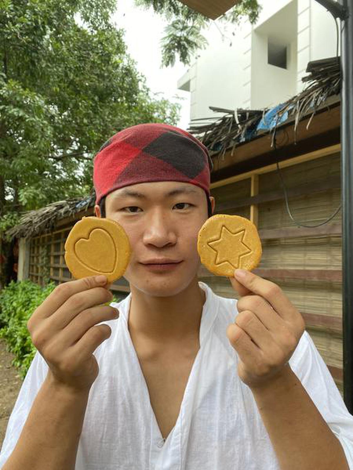 Jeon Minpyo, manager of Korean restaurant Nowana, Aurovile, holding a plate of Dalgona candy discs