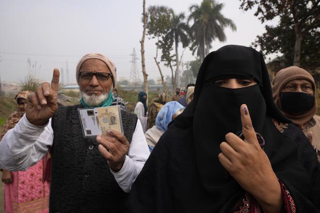 Indian Muslims show their index fingers after casting their vote during the first phase of the Uttar Pradesh state election, in Muradnagar, India.  file.