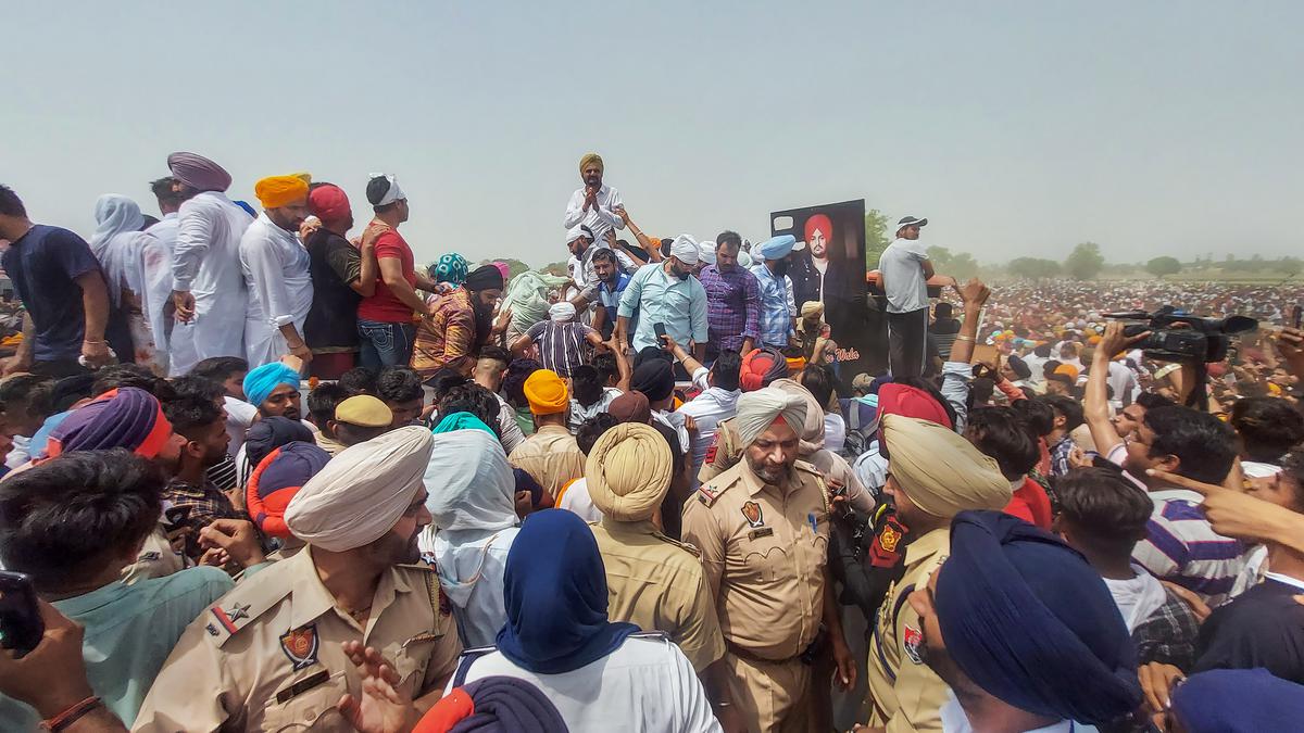 Balkaur Singh, father of Moosewala accepts condolences from supporters and fans of the Punjabi singer, during his last rites, in Mansa district, on May 31, 2022. 