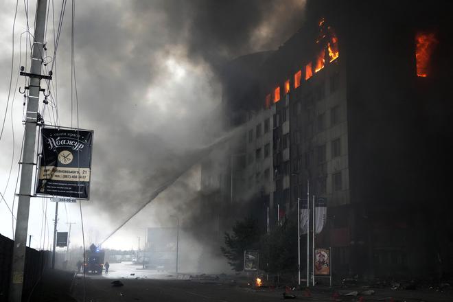 Firefighters hose down a burning building after bombing in Kyiv, Ukraine, on March 3, 2022.