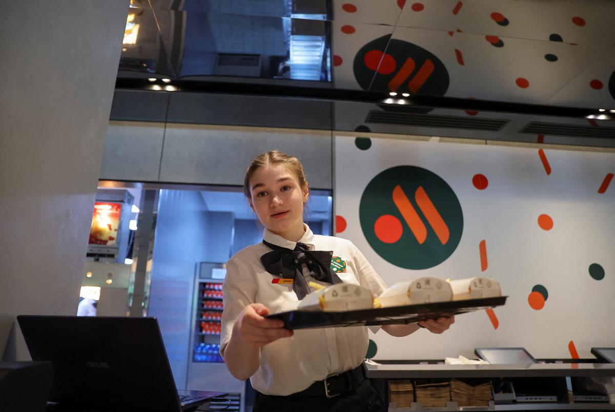 An employee takes part in preparations before the opening of the new restaurant “Vkusno & tochka” following McDonald’s Corp company’s exit from the Russian market in Moscow, Russia on June 12, 2022. 