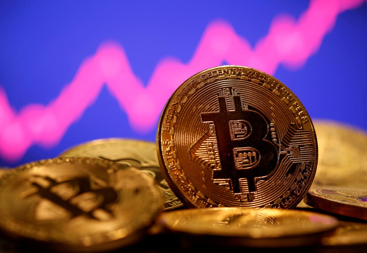 FILE PHOTO: FILE PHOTO: A representation of virtual currency Bitcoin is seen in front of a stock graph in this illustration taken January 8, 2021. 