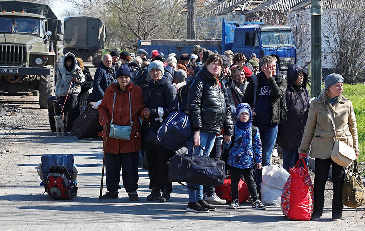 Evacuees wait before boarding a bus to leave the city during Ukraine-Russia conflict in the southern port of Mariupol, Ukraine on April 20, 2022.