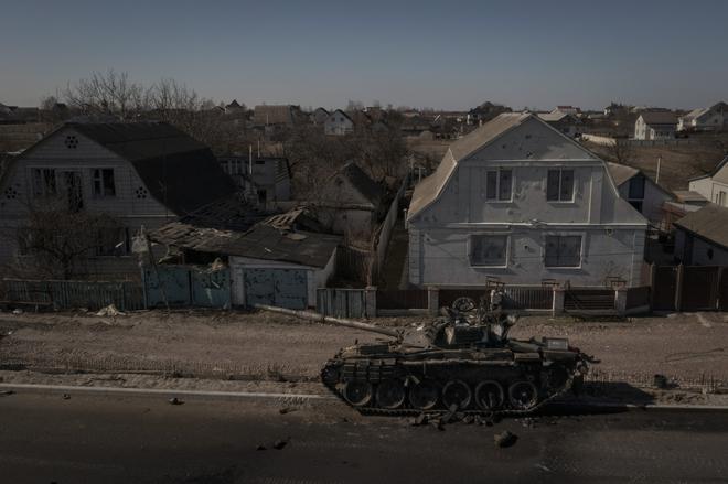 A destroyed tank sits on a street after battles between Ukrainian and Russian forces on a main road near Brovary, north of Kyiv, Ukraine, Thursday, March 10, 2022. (AP Photo/Felipe Dana)