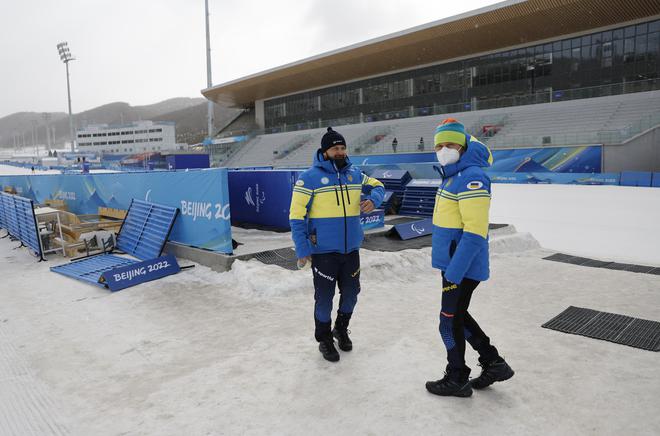 Ukraine team members check the conditions during bad weather ahead of the Beijing 2022 Winter Paralympic Games.