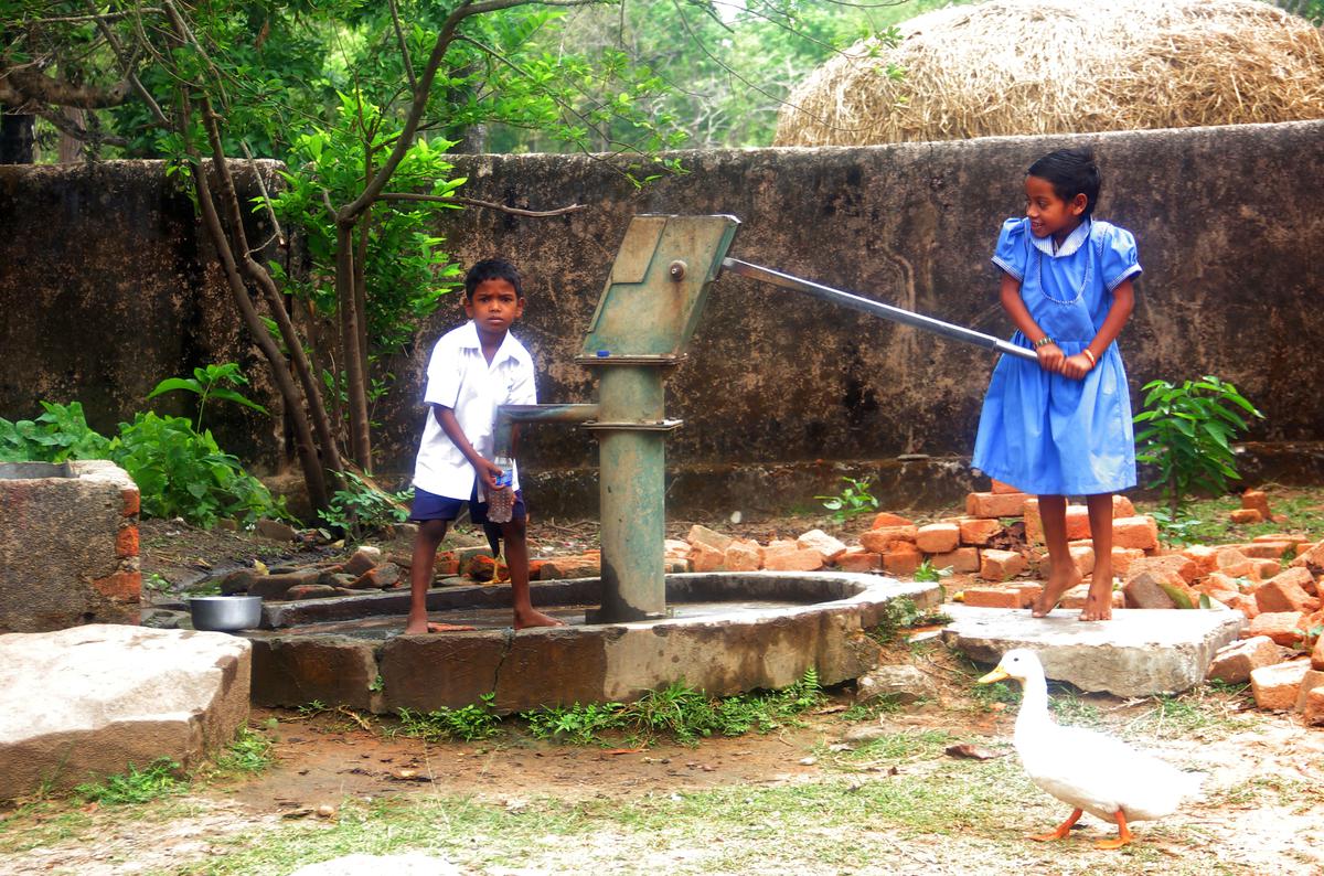 Children use a hand pump on their school campus at Dumuhani village in Mayurbhanj district.