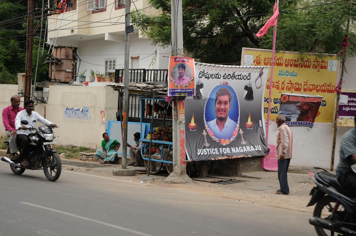 A poster of Nagaraju is hung at the site where he was murdered on Saroornagar main road in Hyderabad. 