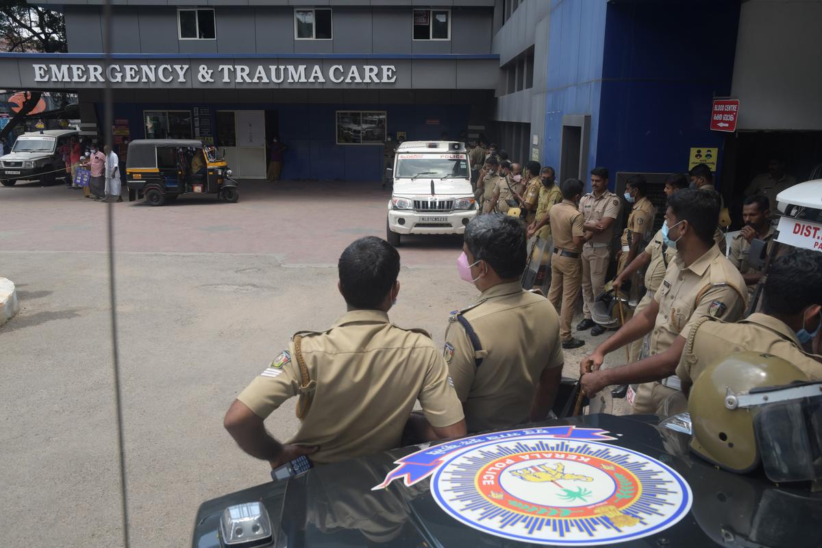 A posse of police personnel stand guard outside the General Hospital at Palakkad where RSS worker Sreenivasan’s body was kept for postmortem on April 17, 2022. 