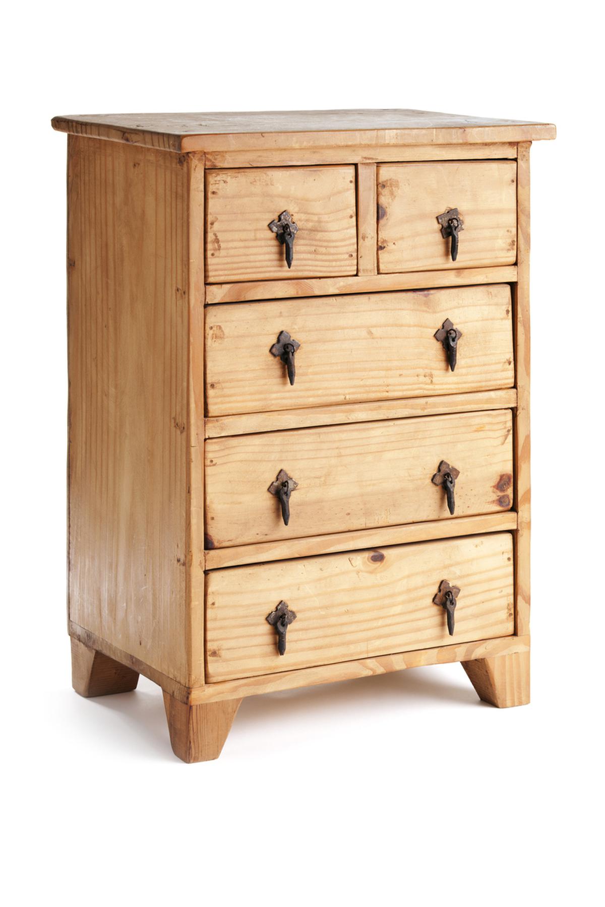 Rustic small wooden chest of drawers cabinet built in the classic American Southwest furniture style from natural pine wood. The basic piece has a plain and simple design, with handles crudely formed of wrought iron metal. Vertical format, cut out and isolated on white background with no people.