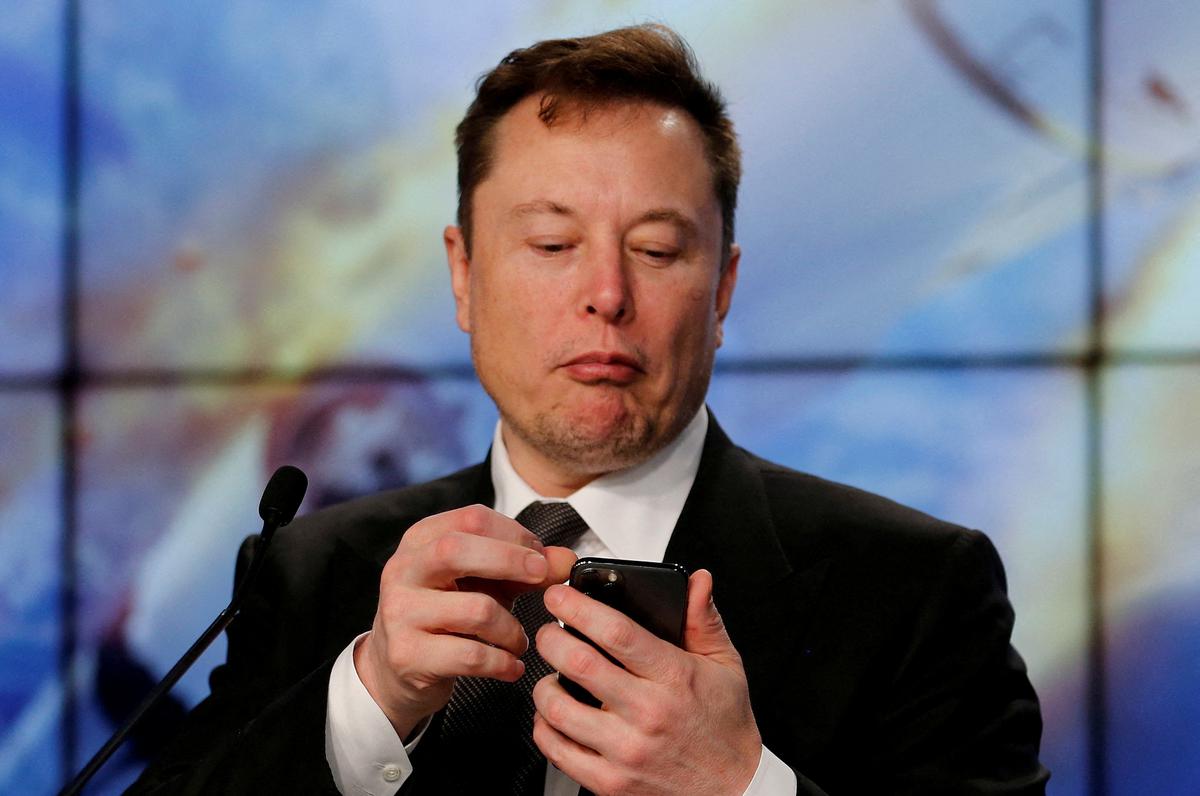 Elon Musk looks at his mobile phone in Cape Canaveral, Florida.