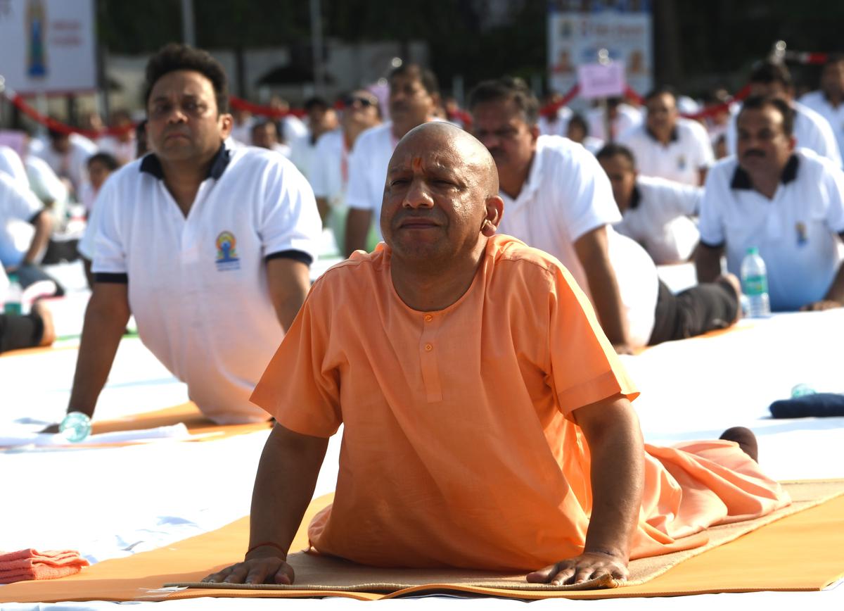 Uttar Pradesh Chief Minister Yogi Adityanath and others performing yoga during the 8th International Yoga Day celebration at Raj Bhawan, in Lucknow on Tuesday, June 21, 2022.