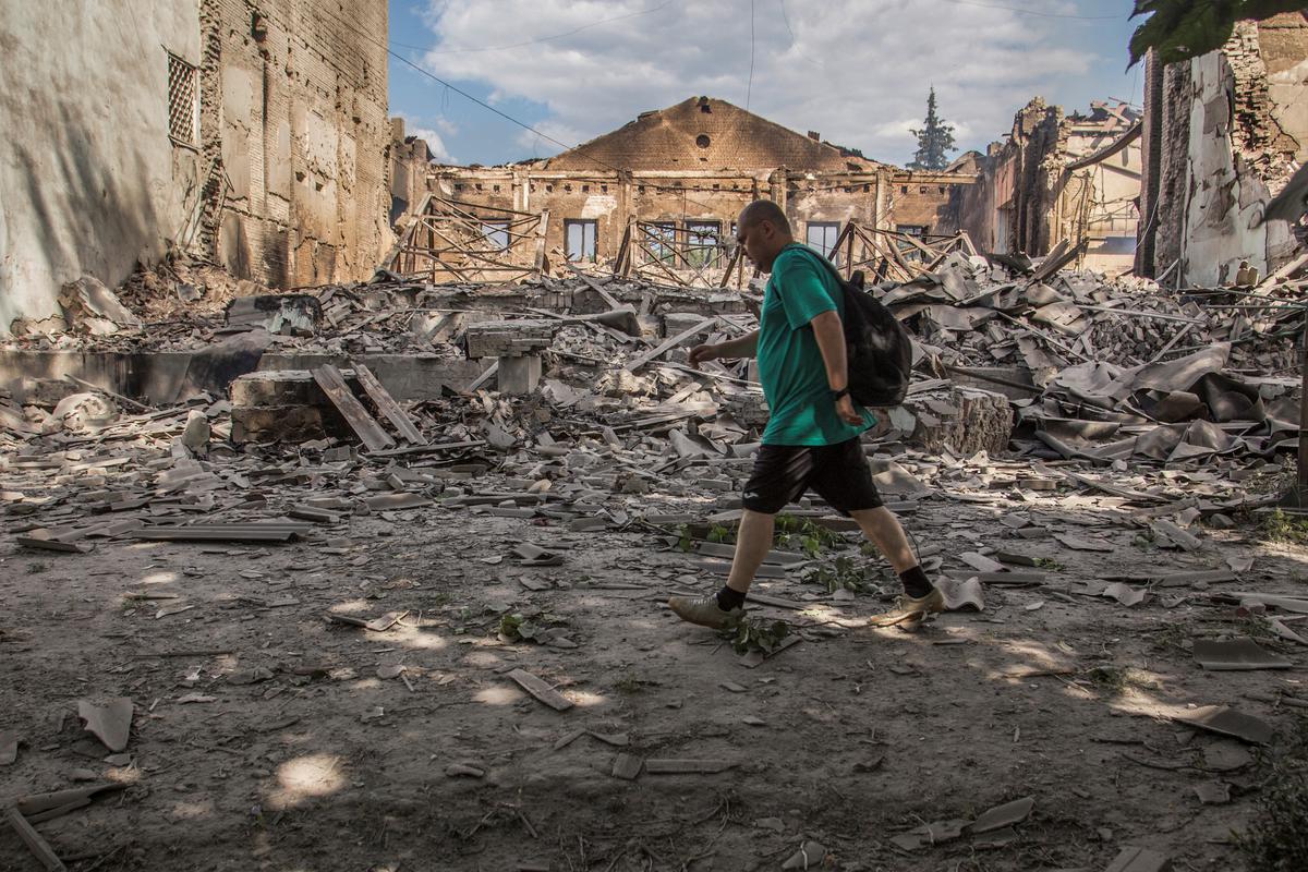 A local resident walks in a front of a building destroyed by a military strike, as Russia’s attack on Ukraine continues, in Lysychansk, Luhansk region, Ukraine on June 17, 2022.