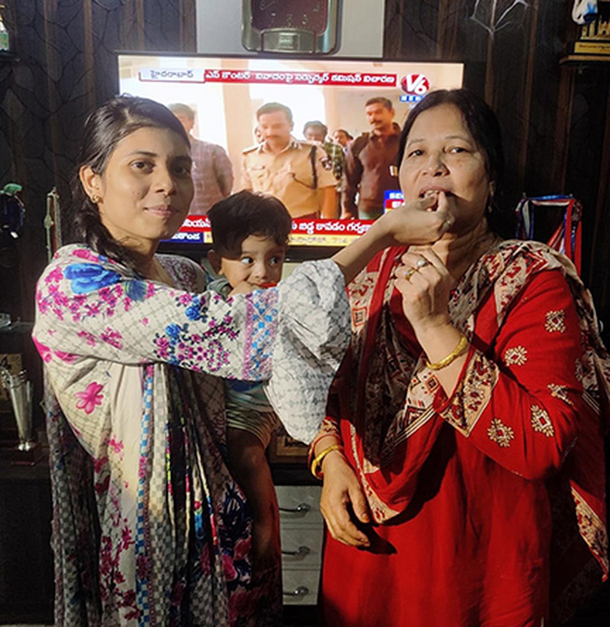 Parveen Sultana, mother of the newly-crowned Women’s World Boxing
Champion Nikhat Zareen, being offered sweets by her second daughter
Anjum Meenaz, at her residence, in Hyderabad, on Thursday. Photo: Special Arrangement