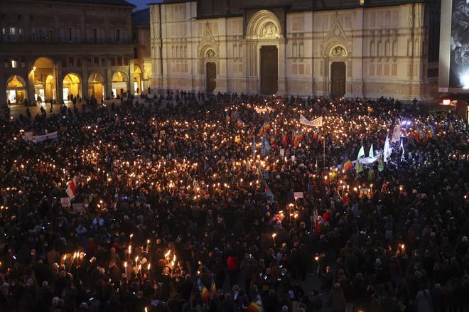 People gather for a candlelight procession in Bologna, Italy, following the Russian attack of Ukraine.