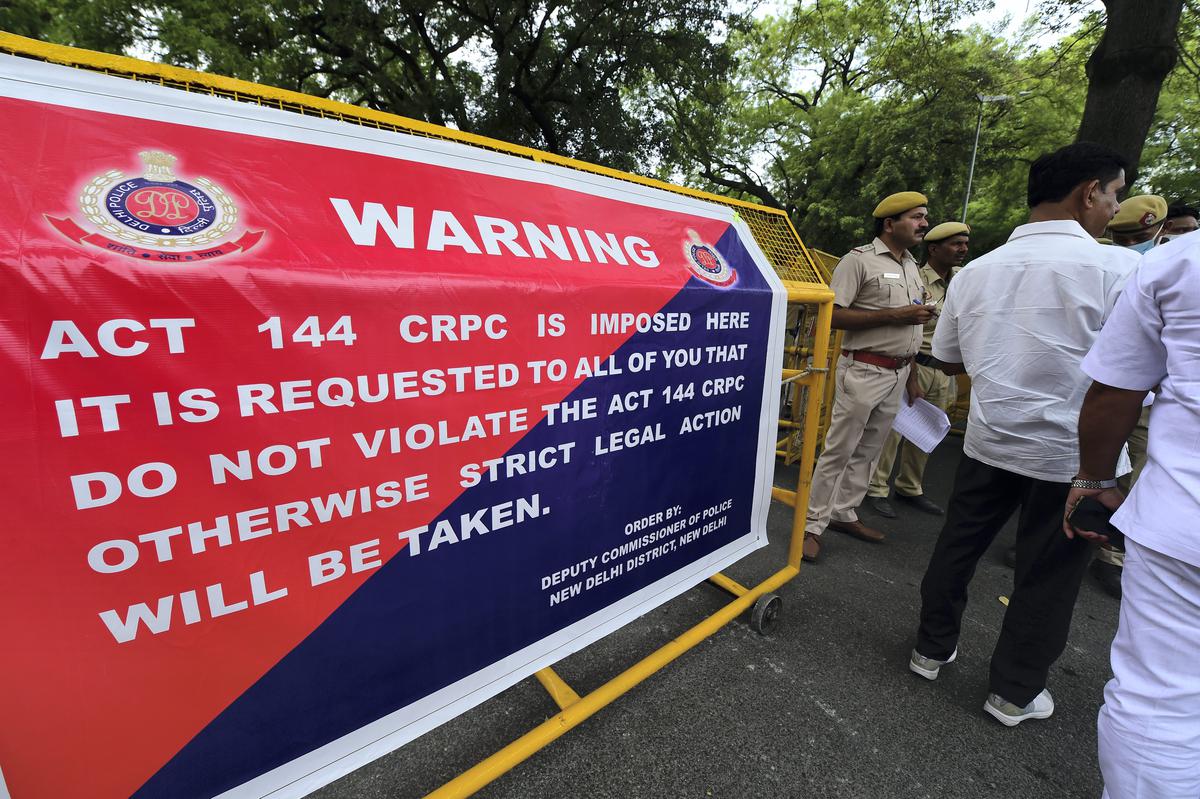 Security personnel outside AICC office, with a barricade informing about the imposition of Section 144 Code of Criminal Procedure in the area, in New Delhi on June 13, 2022. 