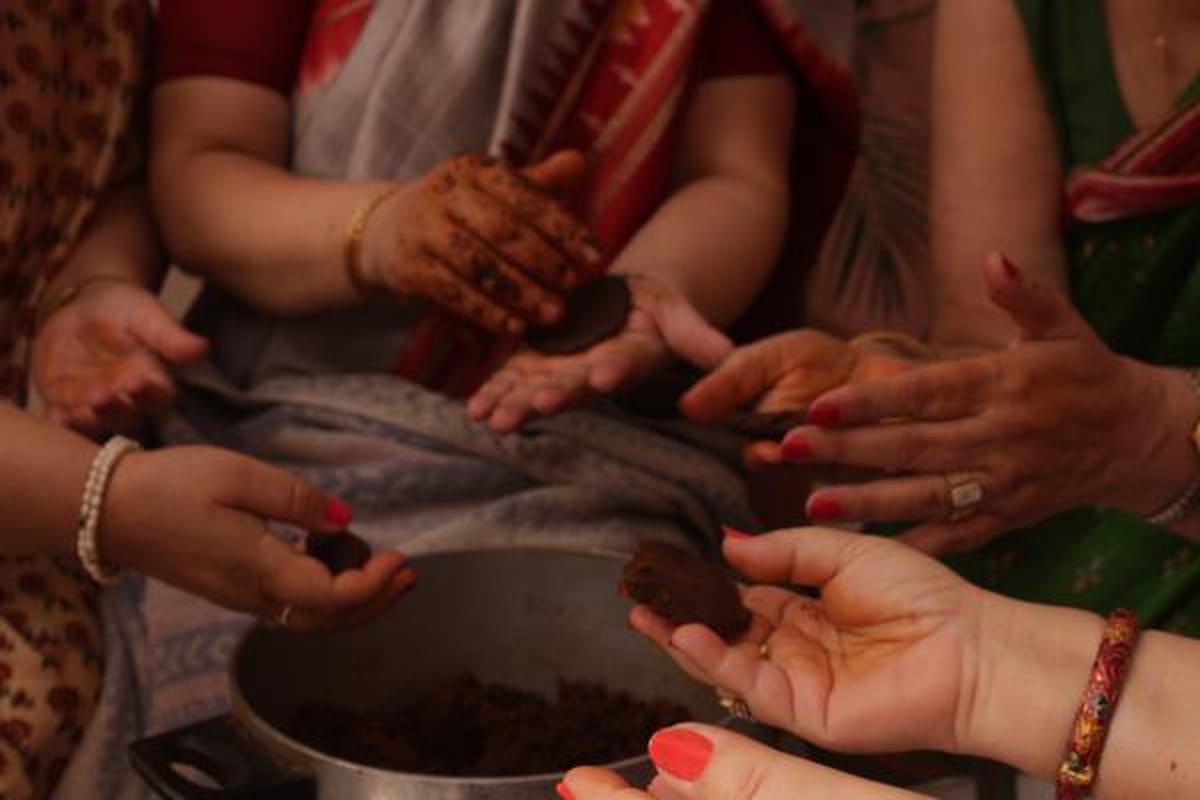 Women at a community cooking event making Badiyaan Masala