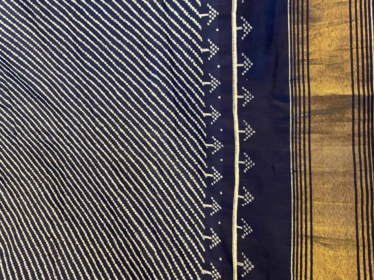 A double ikat patan patola created with mathematical precision by resisting tie-and-dye before weaving.  Designed by Rakesh Thakore for Vishwakarma, looms weren't making this pattern until Malavika's Saree of Memory project revived it.