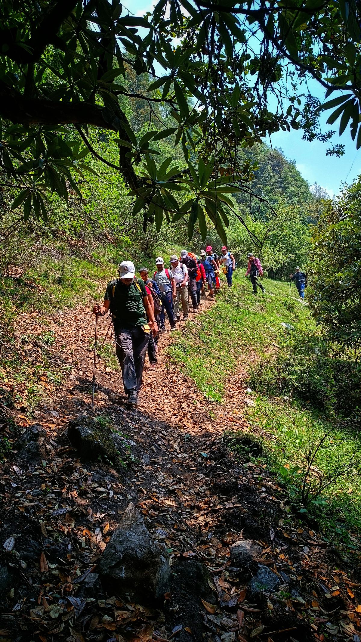 Trekkers crossing the Gui village in Dayara Bugyal