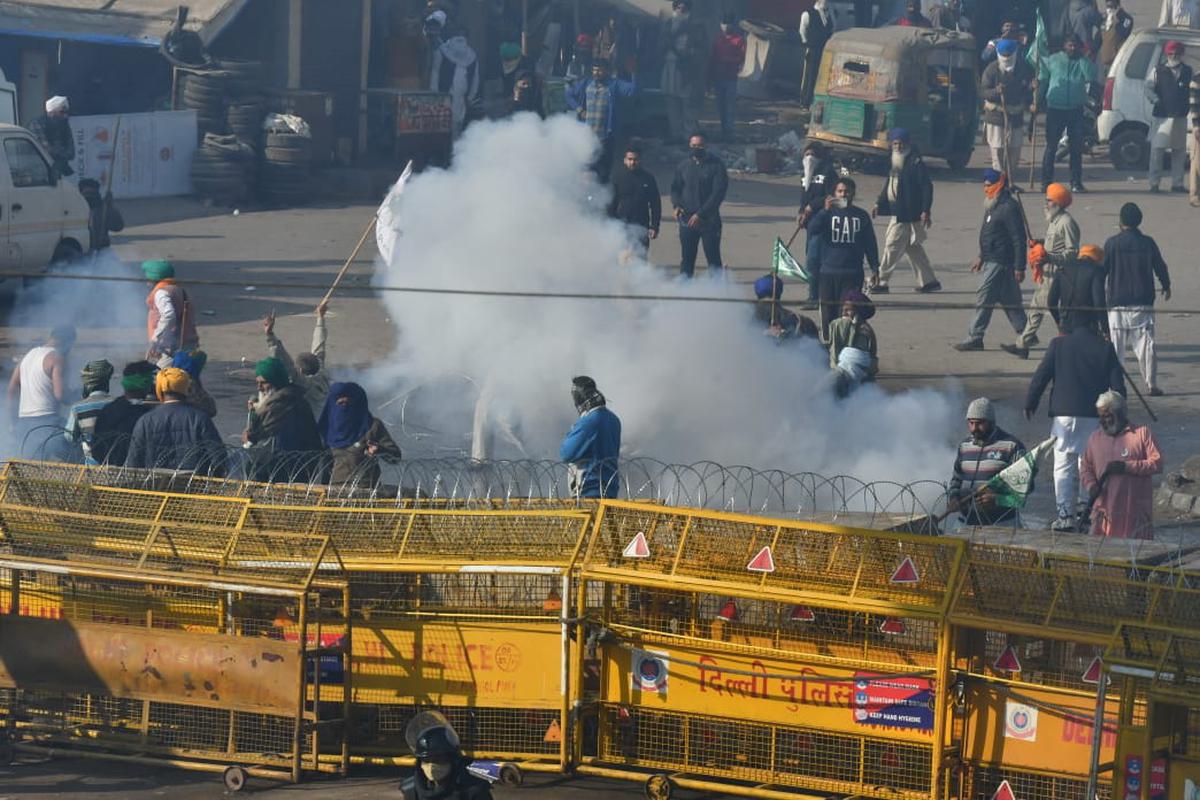 Tear gas being used by security personnel during farmers protest at Tikri Border in New Delhi on Friday.