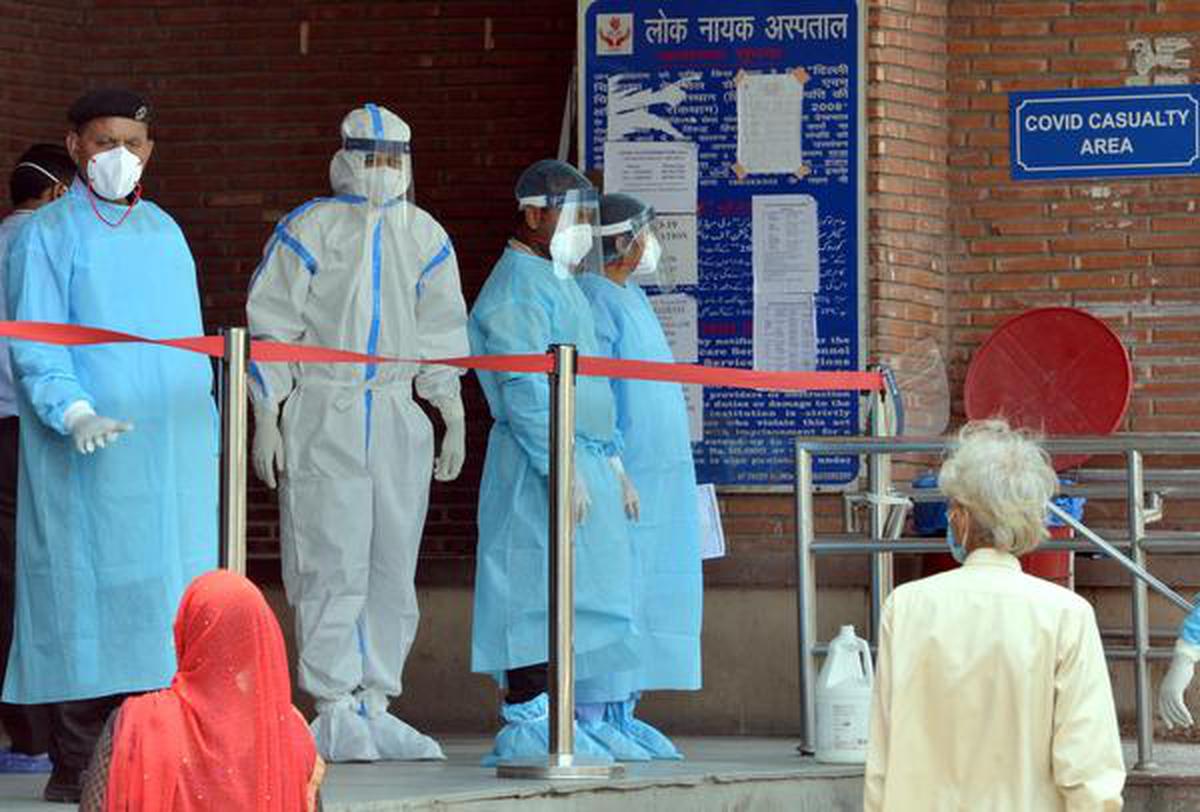 Hospital staff guiding patients at Lok Nayak Hospital in New Delhi on Monday.