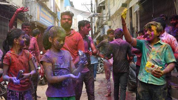 Holi revellers paint the town red
