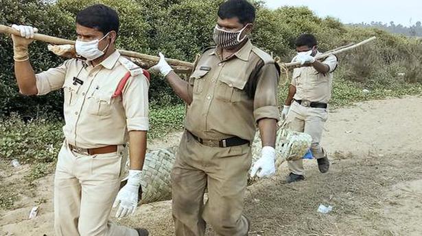 Police officials carry unidentified body in a ‘doli’ for 3 km