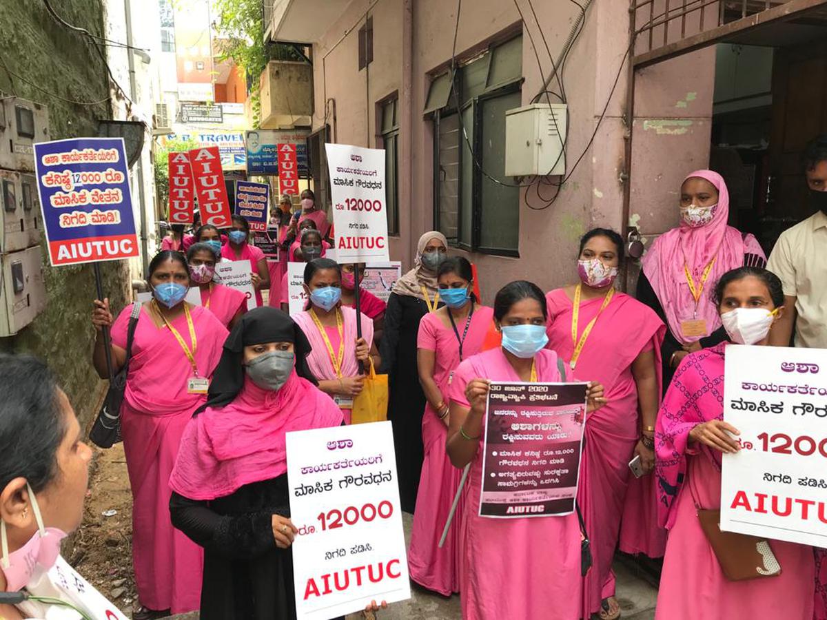 Accredited social health activist (ASHA) workers along with AIUTUC protesting against the government for not providing safety kits during their work in COVID-19 affected areas, at Malleswaram in Bengaluru on June 30, 2020. They demanded an immediately release Rs. 3000, which the government had announced a month ago.