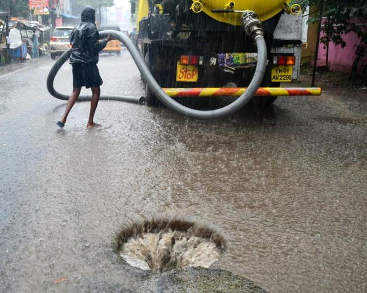 A manhole being opened to prevent rain water stagnation in Kolathur, Chennai on Tuesday, November 24, 2020.