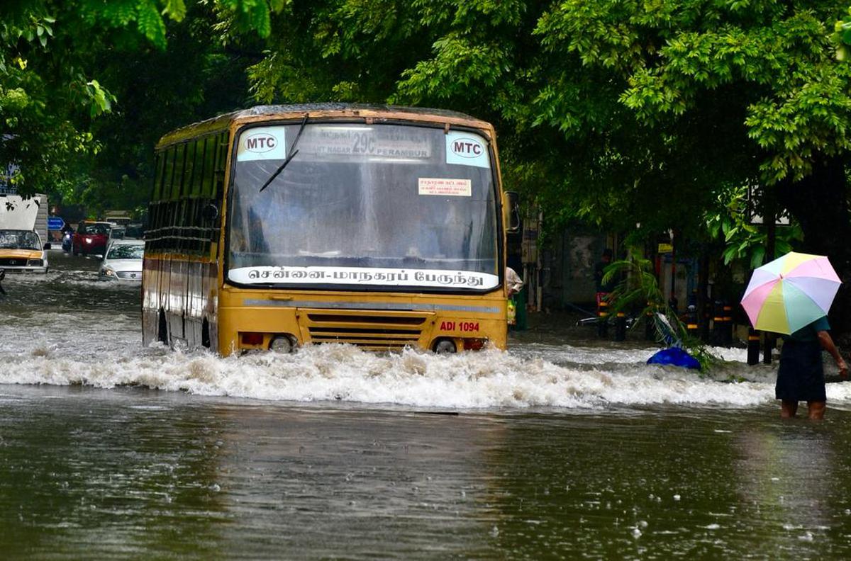 Bus passing through a water-logged street in Chennai on Sunday.