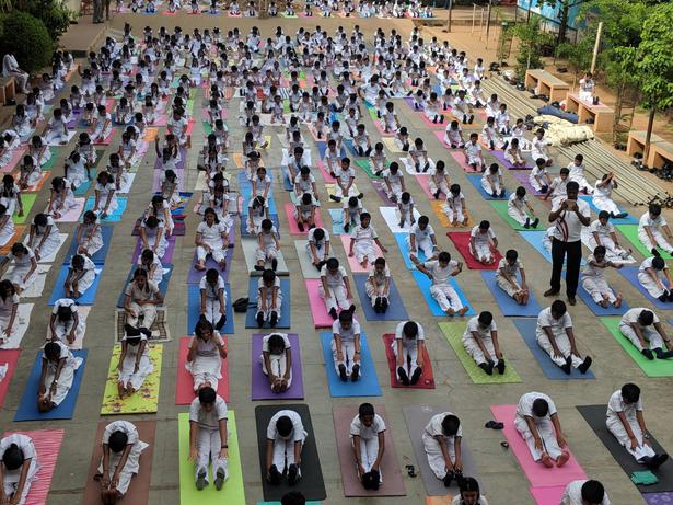 Students of a private school in Chennai practice yoga on International Yoga Day. | Photo Credit: K. Pichumani