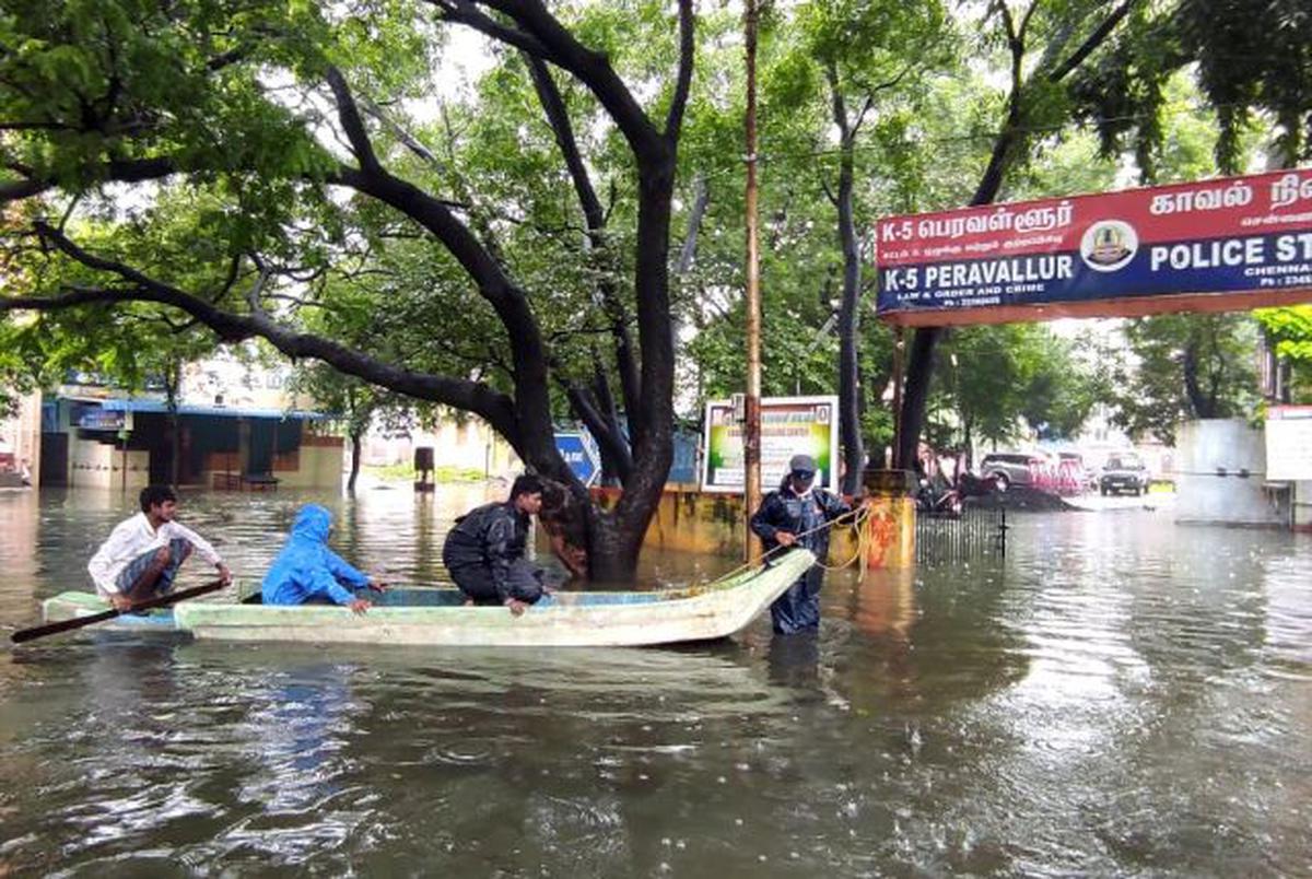 A policeman shifts residents to a safer place by a boat in Peravallur, Perambur on Wednesday, November 10, 2021.