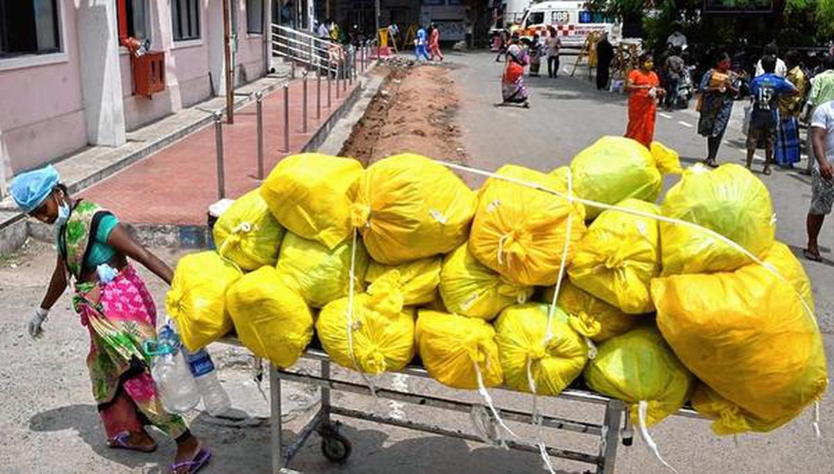 A worker moving medical waste at the Kilpauk Government Medical College Hospital in Chennai.