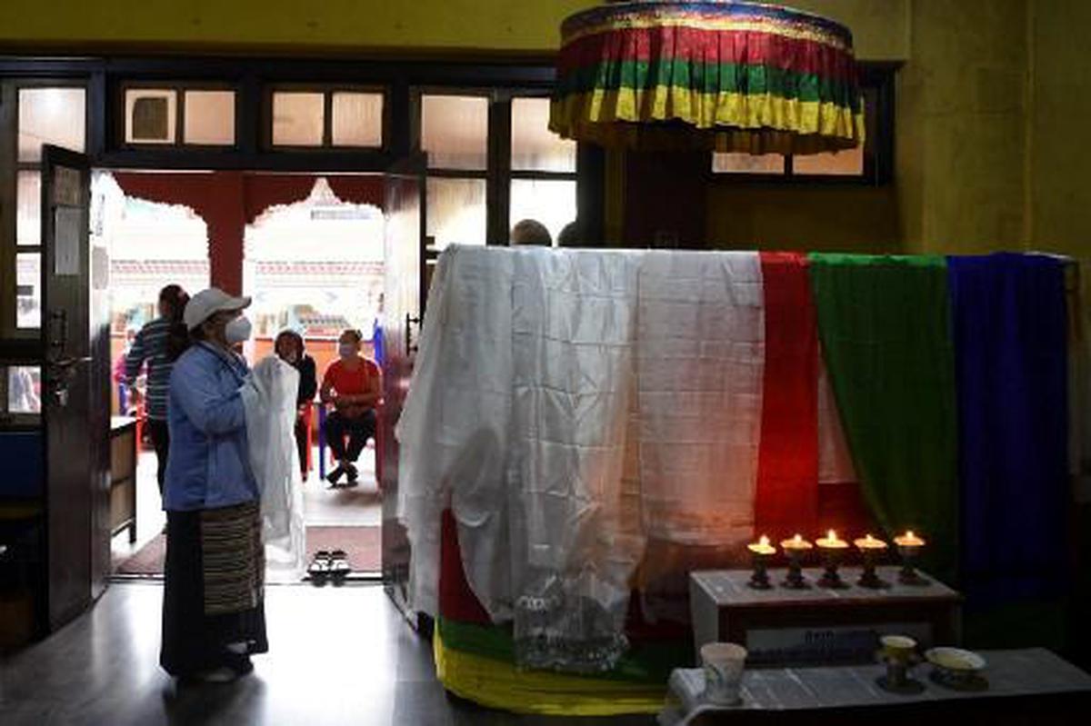 A relative prays in front of the casket of Nepal's veteran mountaineer Ang Rita Sherpa during his funeral ceremony at the Sherpa Monastery in Kathmandu on September 21, 2020.