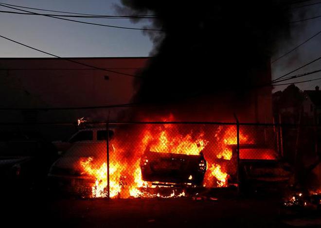 Vehicles are seen on fire during a protest against the death in Minneapolis police custody of African-American man George Floyd, in Minneapolis, Minnesota, U.S., May 29, 2020.