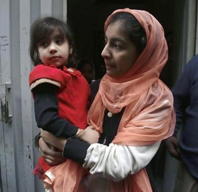Hadiya Khalil, who survived the shoot-out, with a relative in Lahore.