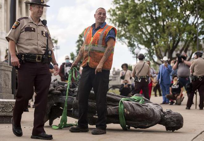 A statue of Christopher Columbus, which was toppled to the ground by protesters, is loaded onto a truck on the grounds of the State Capitol on June 10, 2020 in St Paul, Minnesota.