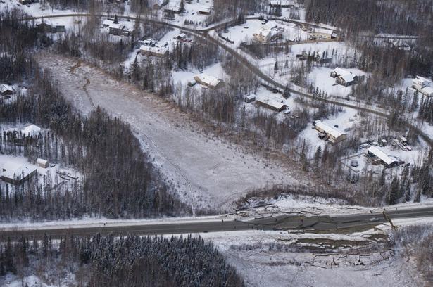 This aerial photo shows damage on Vine Road, south of Wasilla, Alaska, after earthquakes.