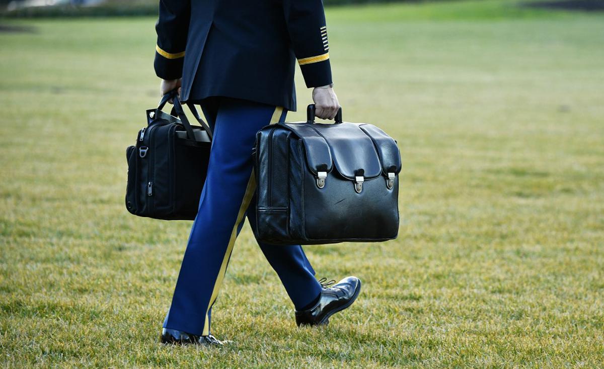 A military aide carries the nuclear “football” with the equipment and nuclear codes to Marine One as U.S. President Donald Trump and First Lady Melania left the White House in Washington D.C. on January 20, 2021.