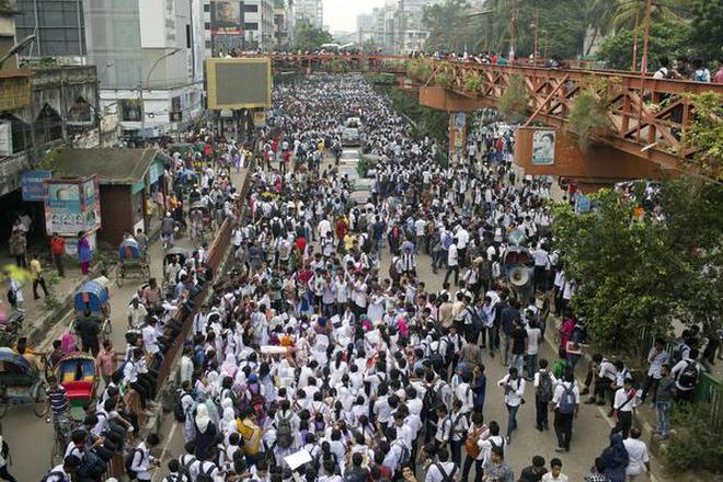 Bangladeshi students shout slogans and block a road during a protest in Dhaka, Bangladesh, on Saturday.