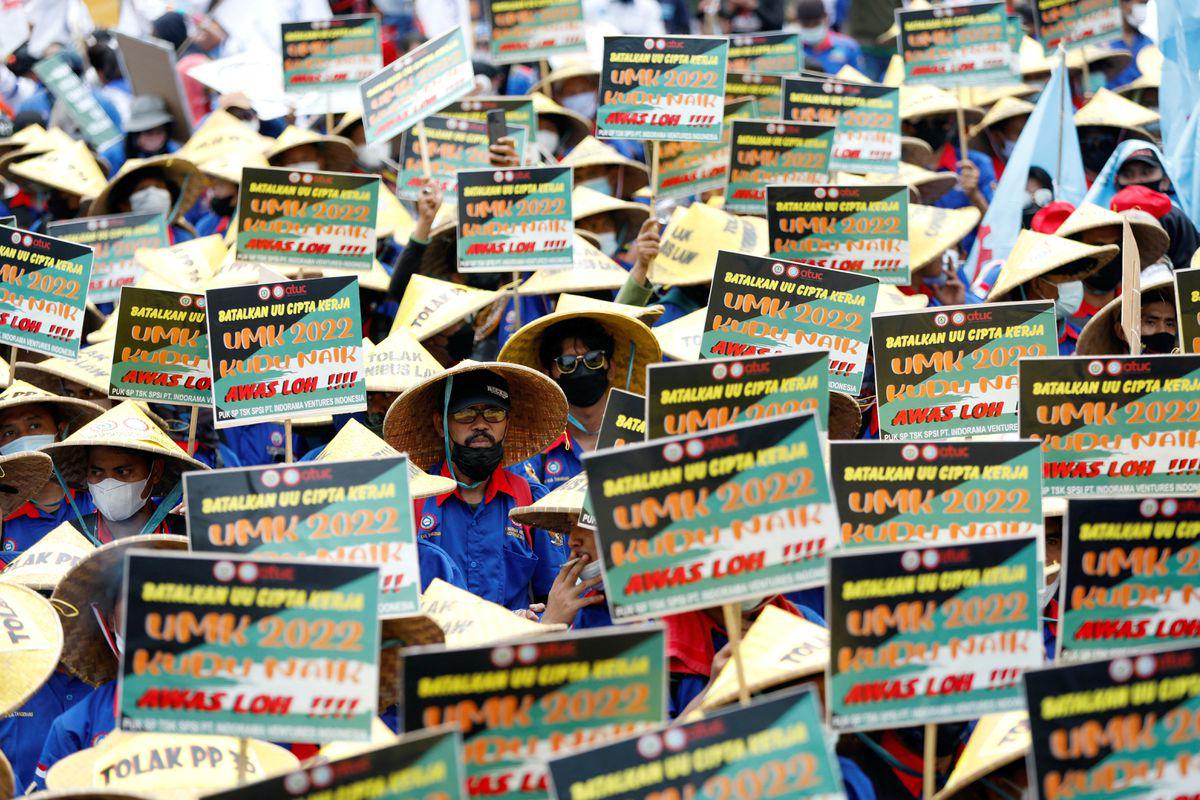 Members of Indonesian trade unions hold placards during a protest against the government’s labour reforms.