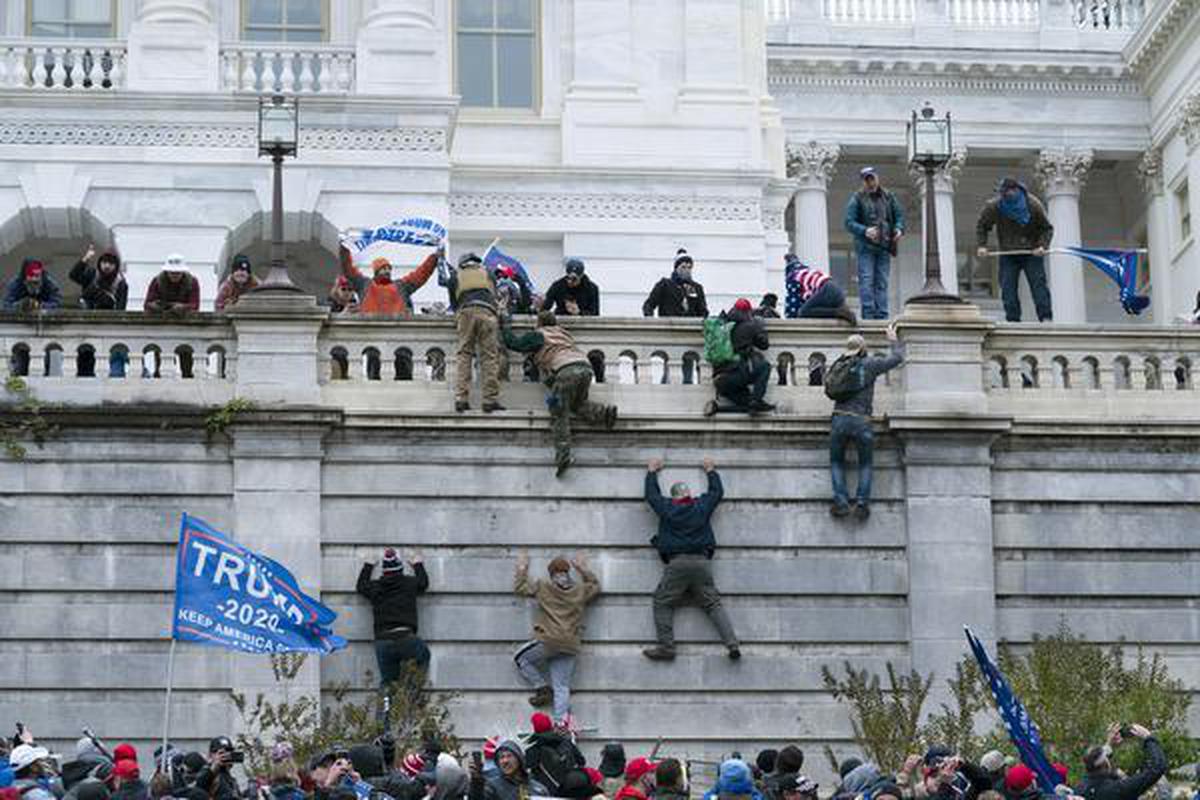 Violent insurrectionists loyal to President Donald Trump scale the west wall of the the U.S. Capitol in Washington, January 6, 2021. File